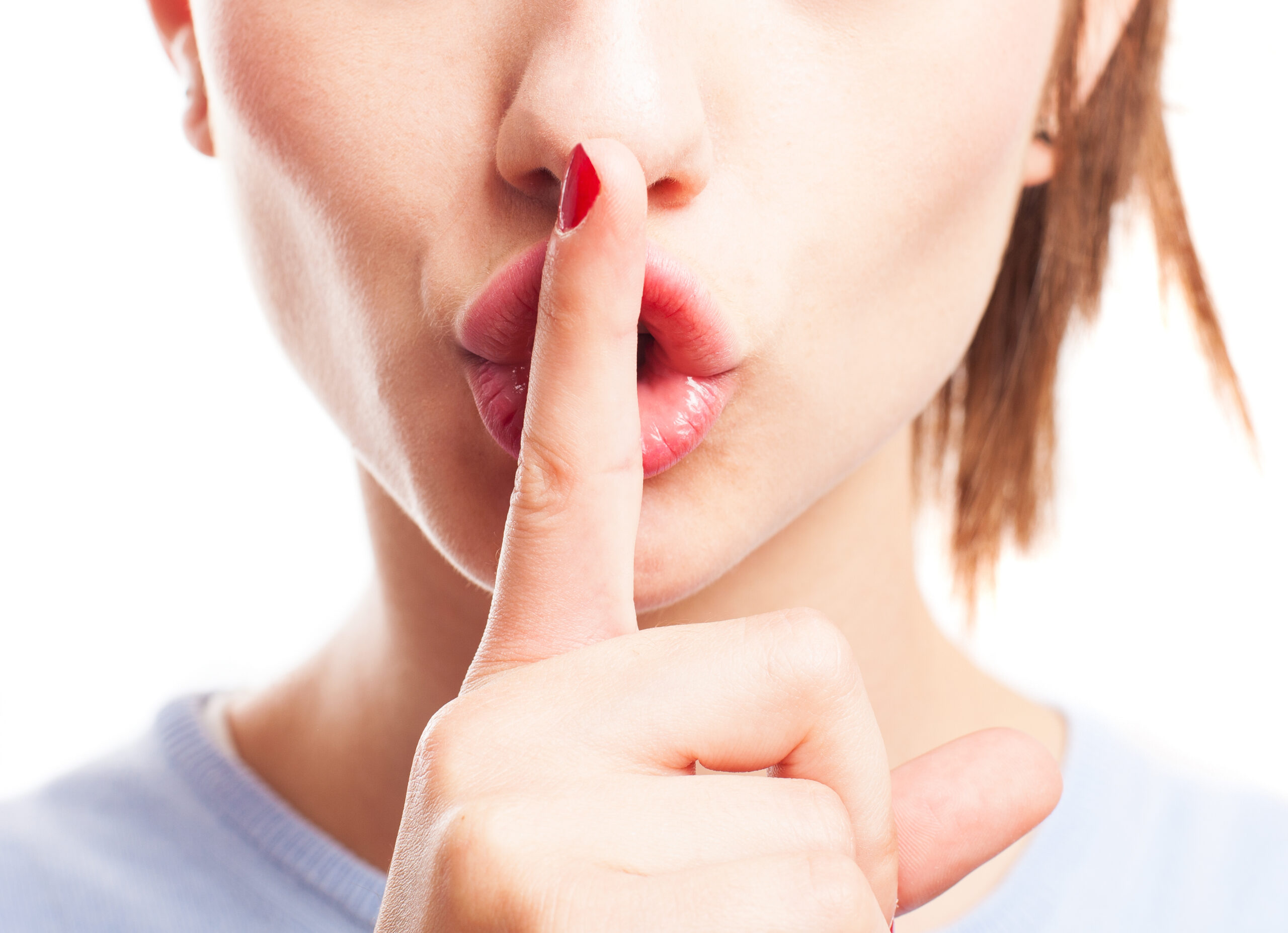 girl asking for silence on a white background