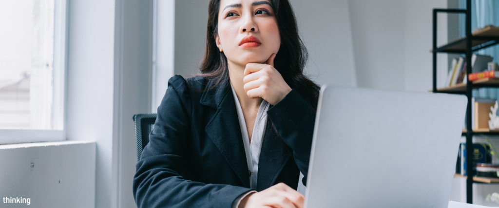 A professional reflecting at her laptop after a difficult conversation