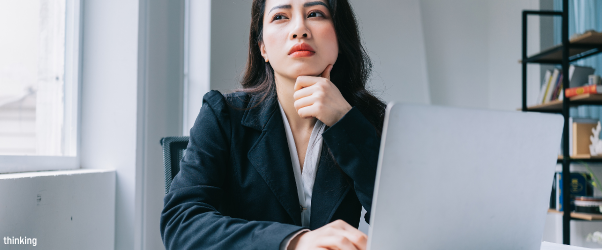 A professional reflecting at her laptop after a difficult conversation